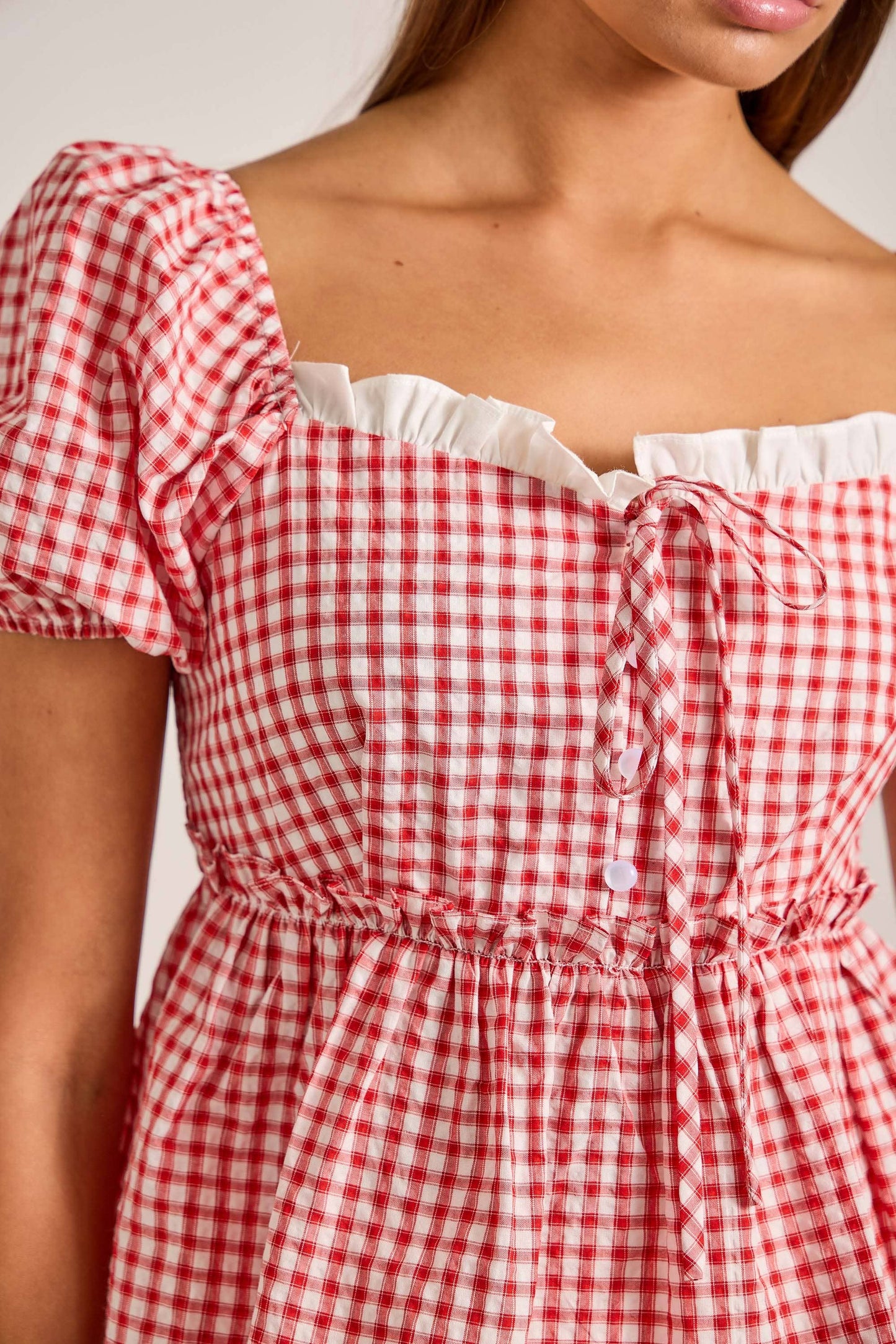 Short puff sleeve gingham top with contrast ruffle detail